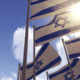 Israel flags against a blue sky with sun shining through