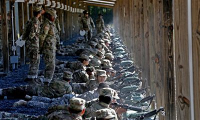 Photo of Army drill sergeants standing over recruits