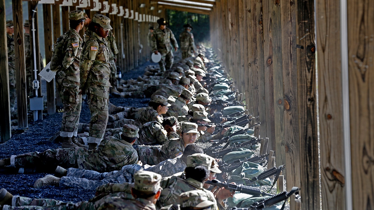 Photo of Army drill sergeants standing over recruits