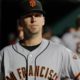 Photo of San Francisco Giants' Buster Posey walking in the dugout