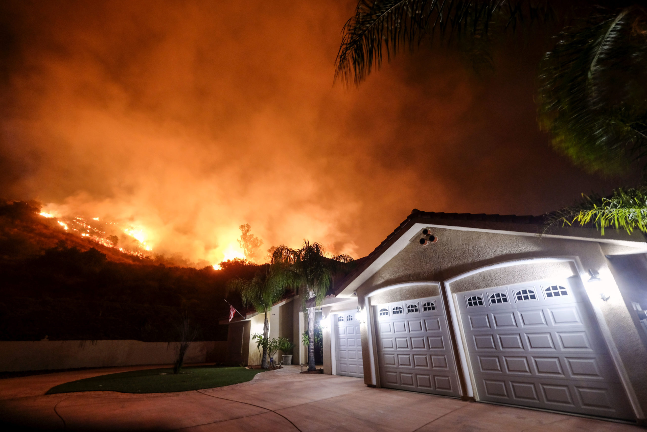 Photo of fire burning near a neighborhood in Lake Elsinore, Calif.