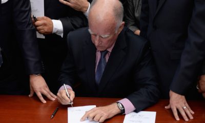 Photo of Jerry Brown signing another bill