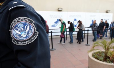 Photo of people crossing from Mexico into the U.S. in San Diego