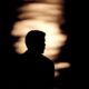 Photo of a man is silhouetted against moonlight reflecting off the Missouri River