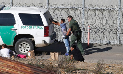 Photo of asylum seeker being taken into custody by US Border Patrol