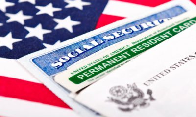 Composite of green card, social security card and American flag