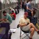 Photo of people sitting in the animal shelter in Phoenix, comforting dogs during 4th of July fireworks