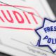 Composite illustration of audit papers and Fresno Police badge