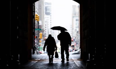 Photo of pedestrians passing beneath City Hall in Philadelphia