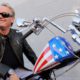 Photo of Peter Fonda on the chopper motorcycle he made famous in Easy RiderDo