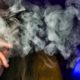 Photo of a person hidden behind vape smoke