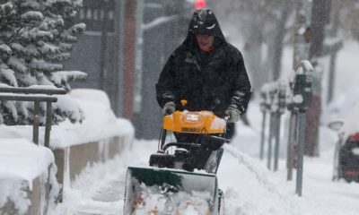 Photo of a man using a snowblower