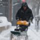 Photo of a man using a snowblower