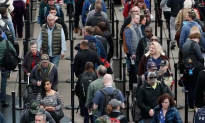 Photo of travelers waiting in line at the Denver International Airport