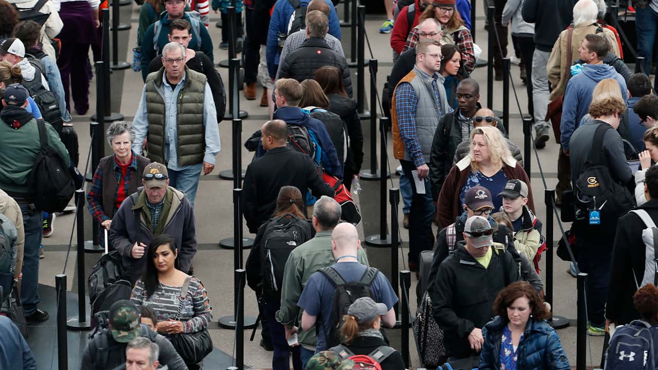 Photo of travelers waiting in line at the Denver International Airport