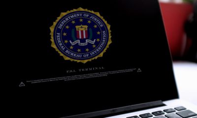 Photo of a laptop with a Department of Justice logo on the screens