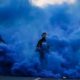 Photo of police officers in blue smoke