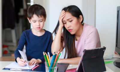 Image of a parent and child frustrated by distance online learning